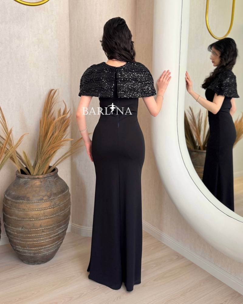Classic black dress with a short sequined cape