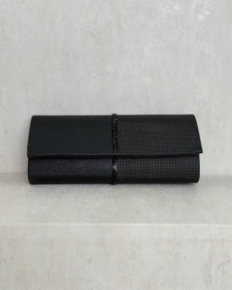 Evening bag decorated with a studded ribbon in the middle