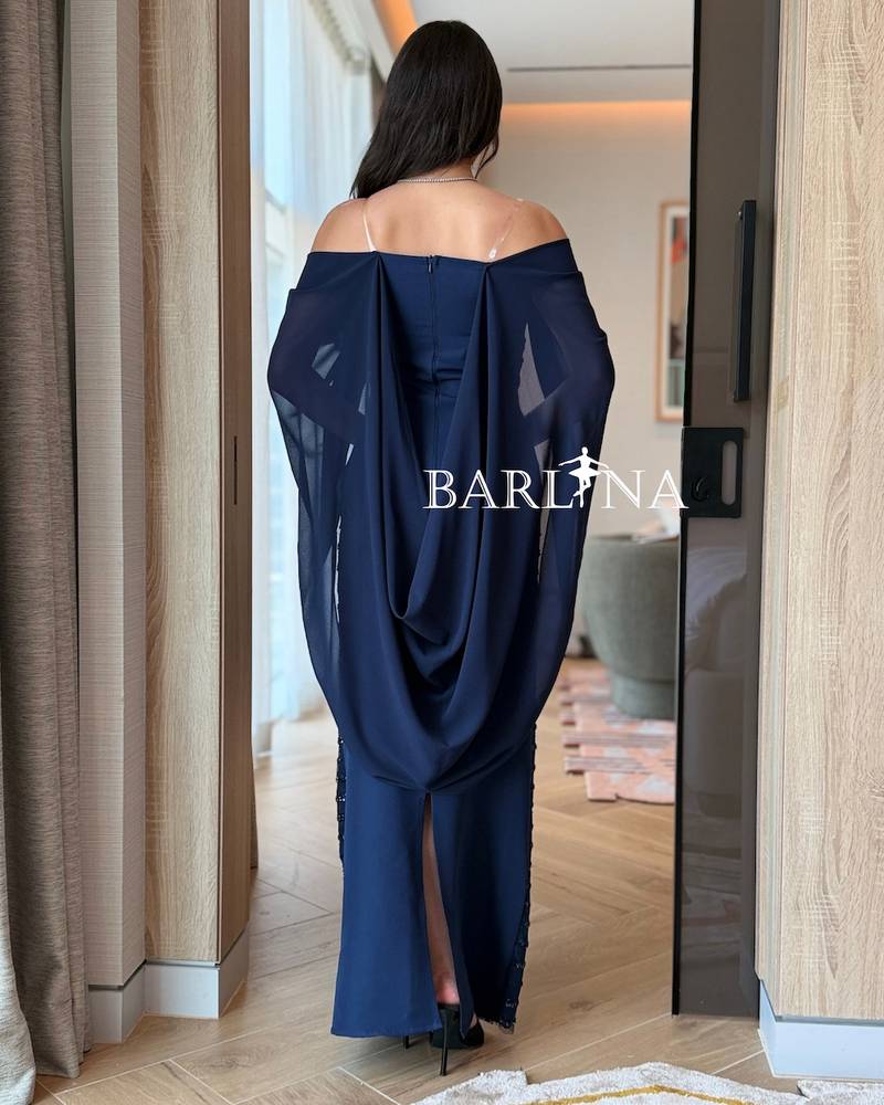 A sparkly navy blue dress with a back cape