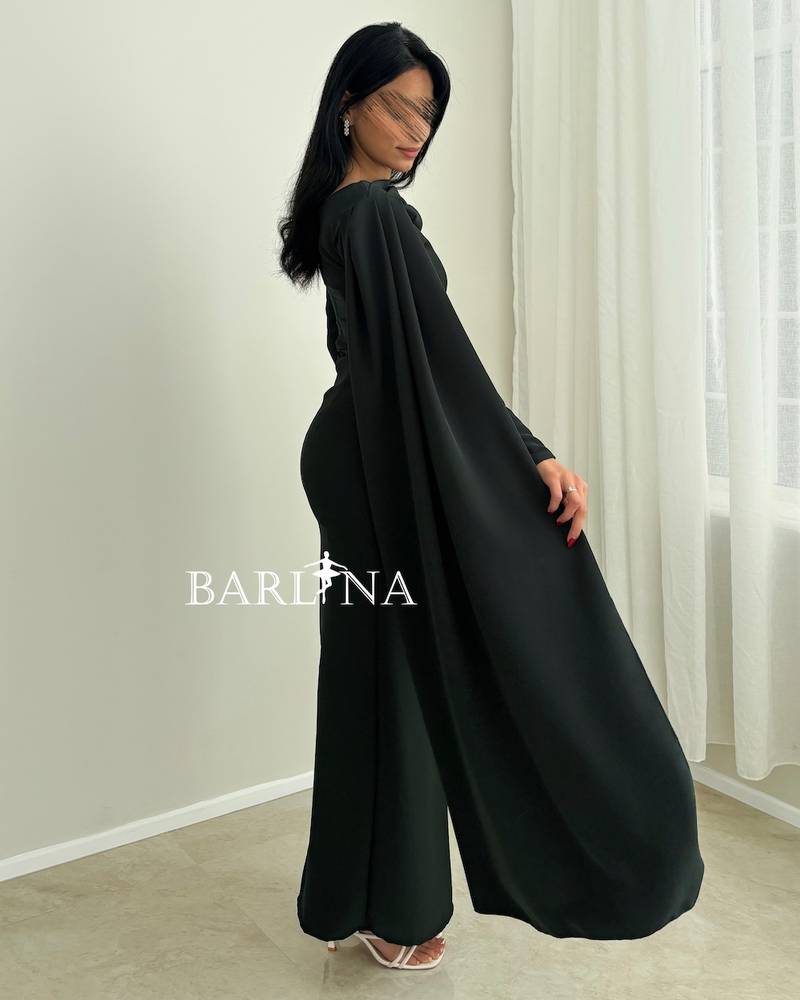 An olive-green dress with a draped cape over the shoulder