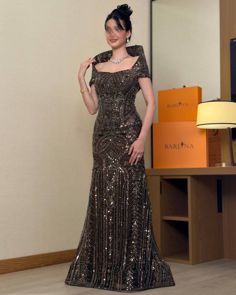 A brown evening dress fully embroidered with sequins