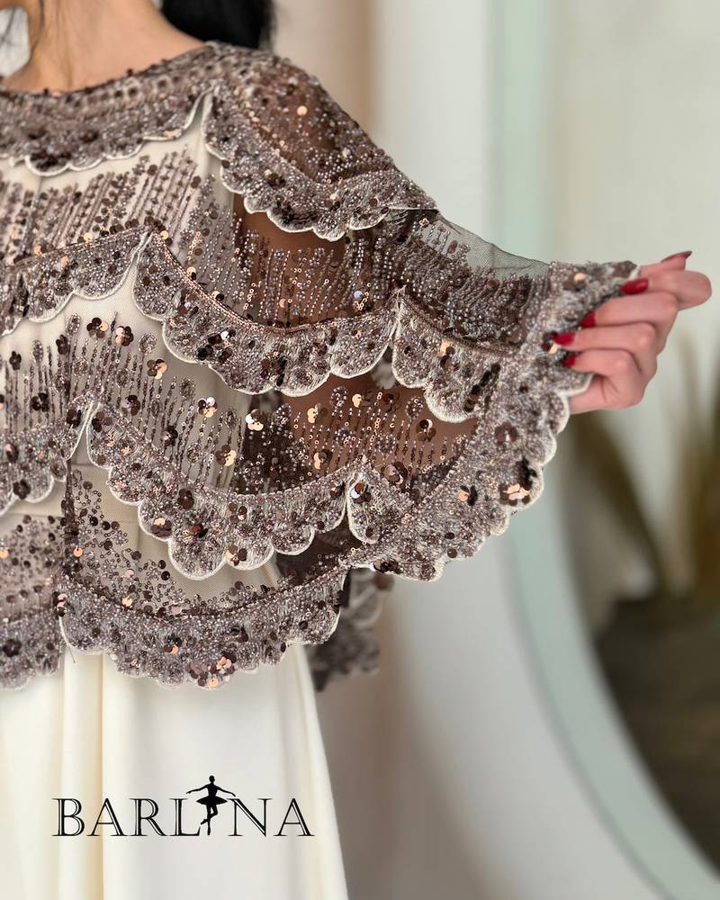 Elegant off-white dress with an embroidered overlay