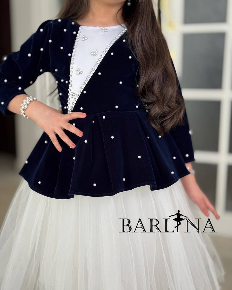 White girl's dress with a navy blue layer and crystals