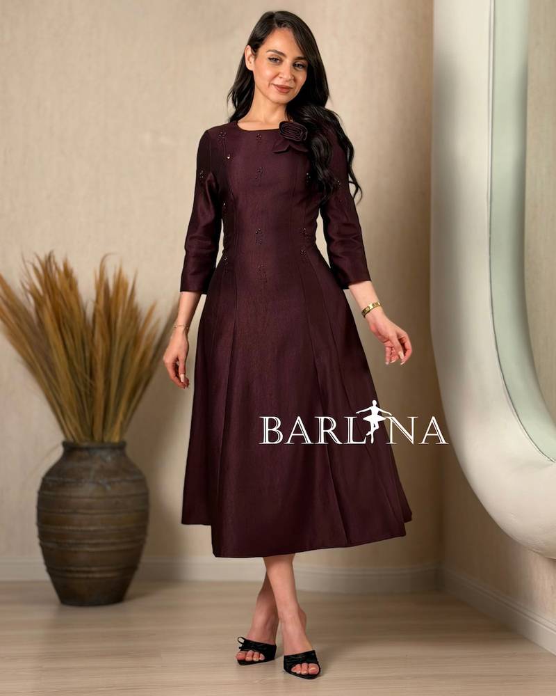 A soft midi dress adorned with a delicate rose