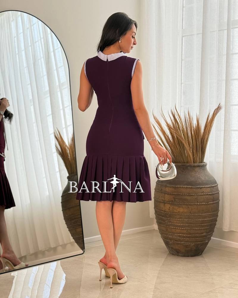 Dark purple dress with a white tie