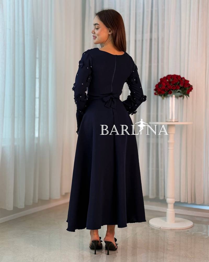 A soft navy dress with a draped collar detail
