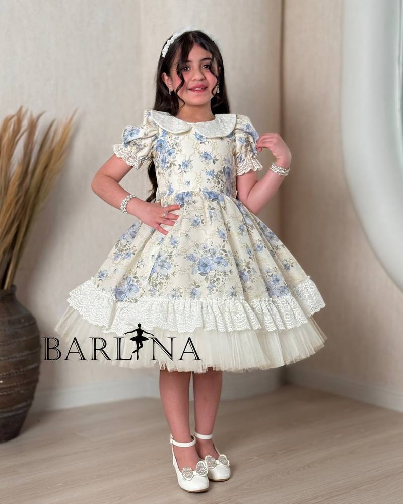 A classic off-white girl's dress with a floral print