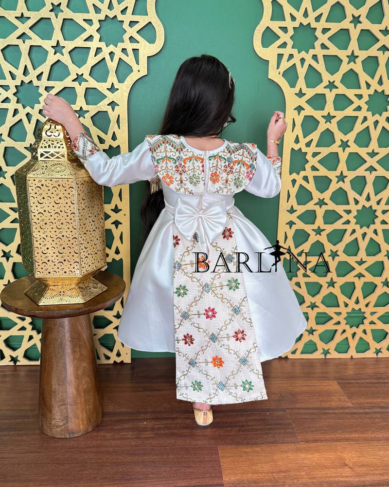 Off-white girls' dress decorated with colorful embroidery