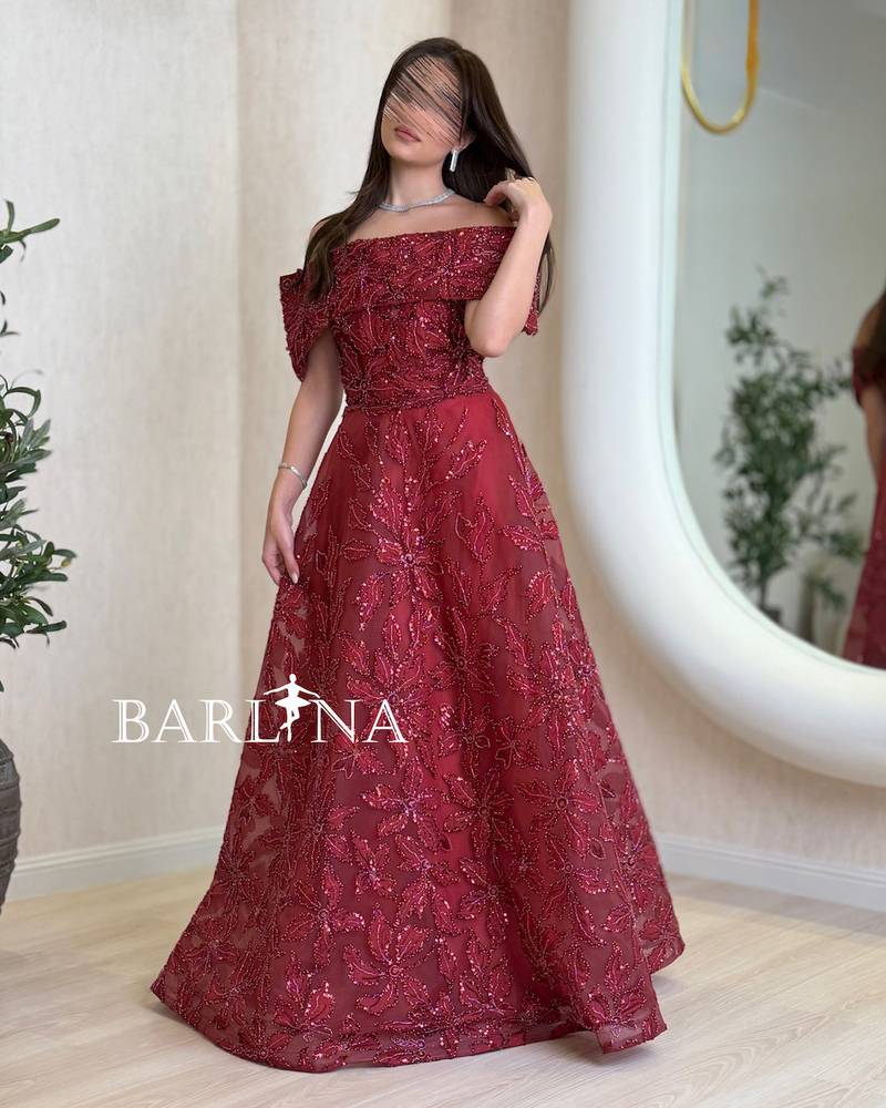 Burgundy dress with shimmering embroidery throughout the design