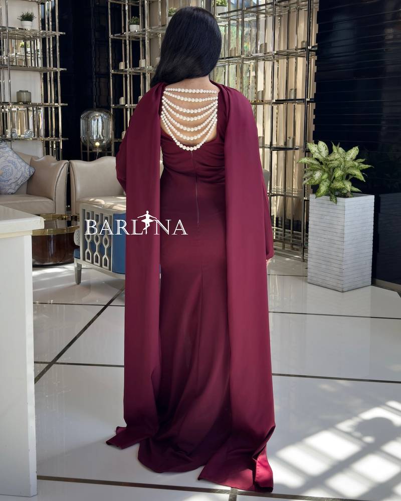 Elegant burgundy dress decorated with pearls on the back