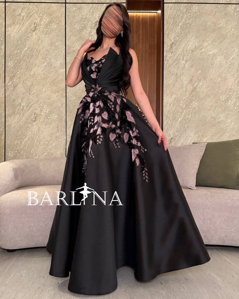 Elegant black evening dress with pleats at the chest