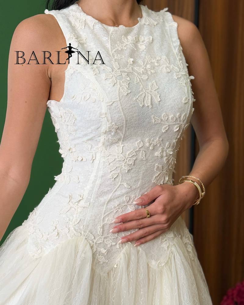 White dress with a light tulle layer over lace