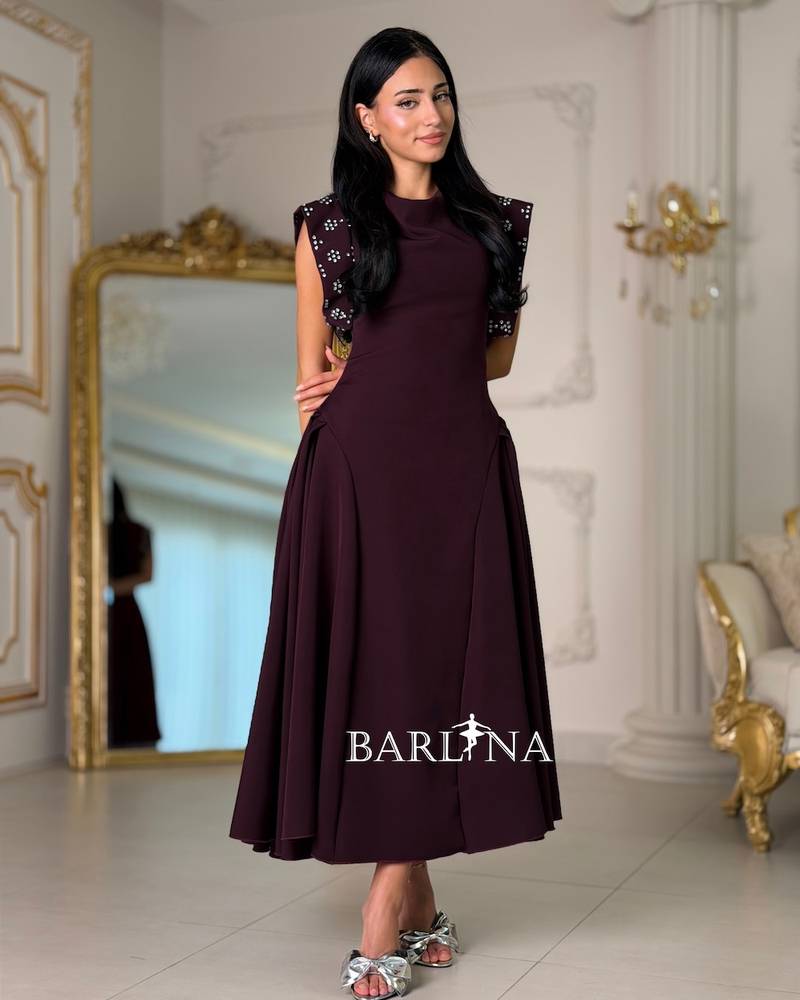 Maroon dress with embroidered shoulders and a flared silhouette