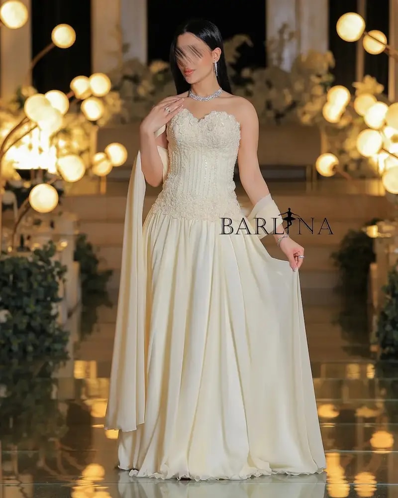 Royal ivory evening gown with draped sleeves