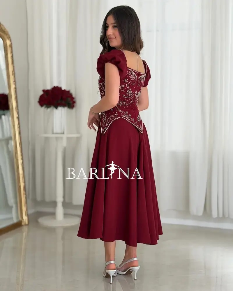 A flowing red dress with elegant beadwork
