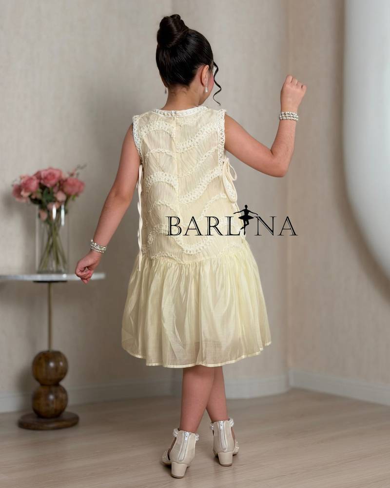 Girls dress in a soft cream color