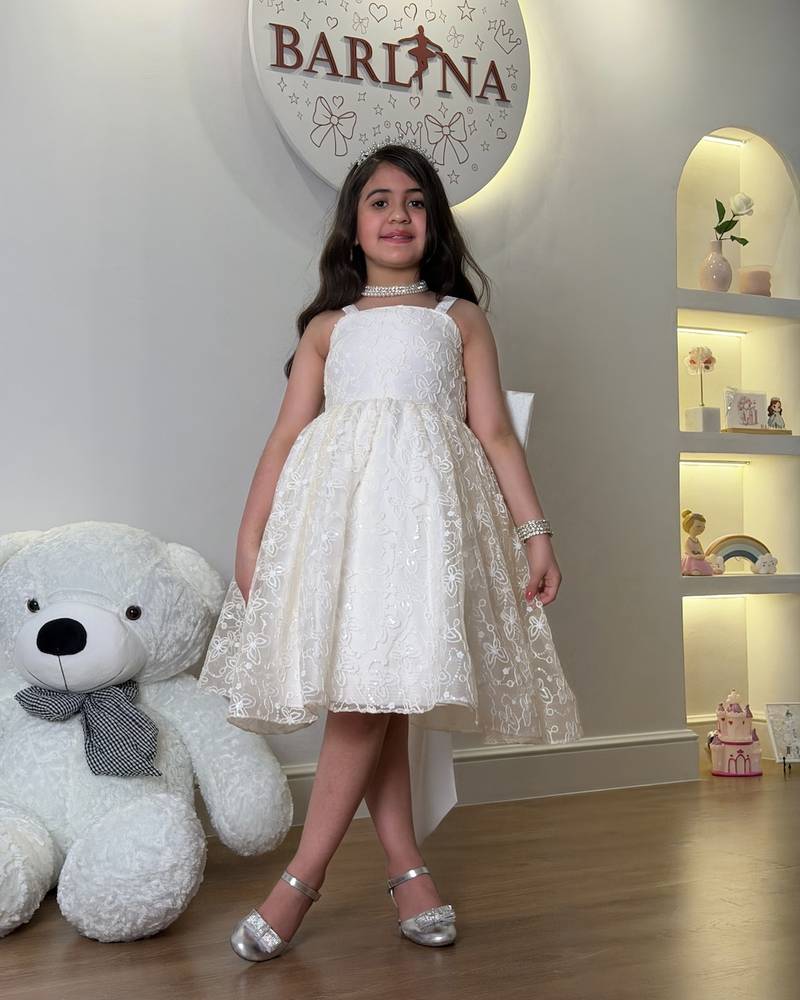 short off-white girl's dress with a bow at the back