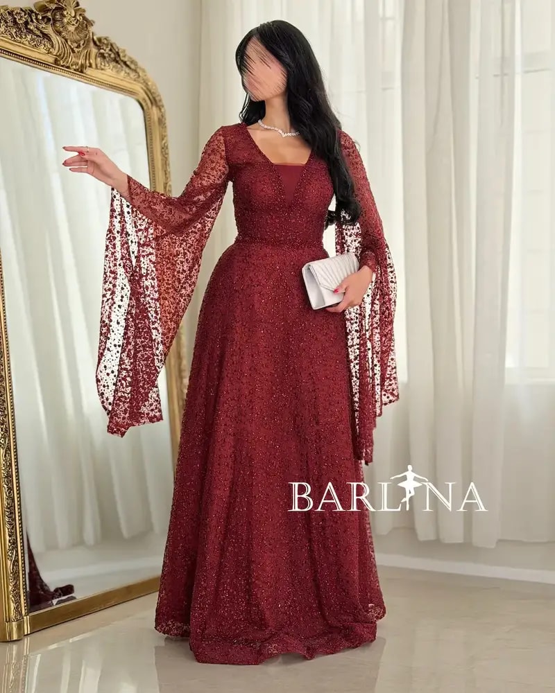 Red evening dress adorned with shimmering embroidery