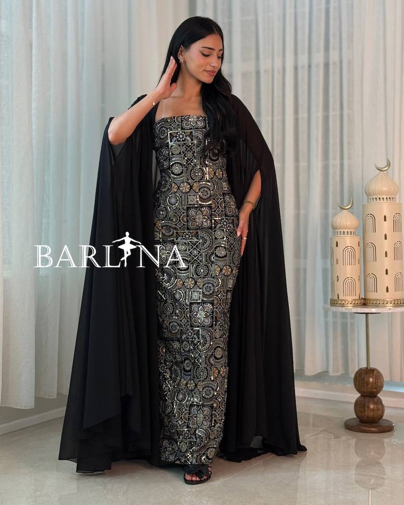 A black jalabiya adorned with luxurious gold patterns