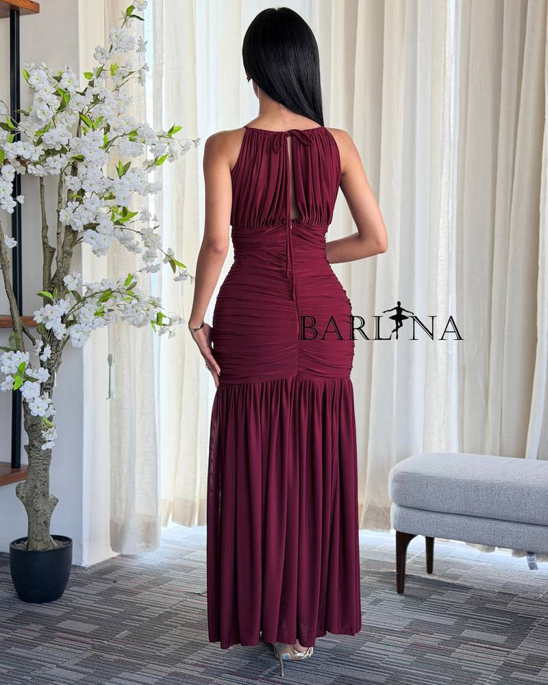 A fitted burgundy dress with soft pleats