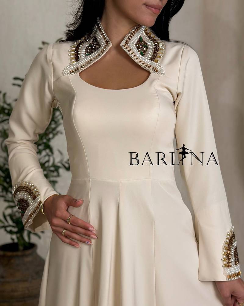 Beige dress with patterns on the neck and sleeves