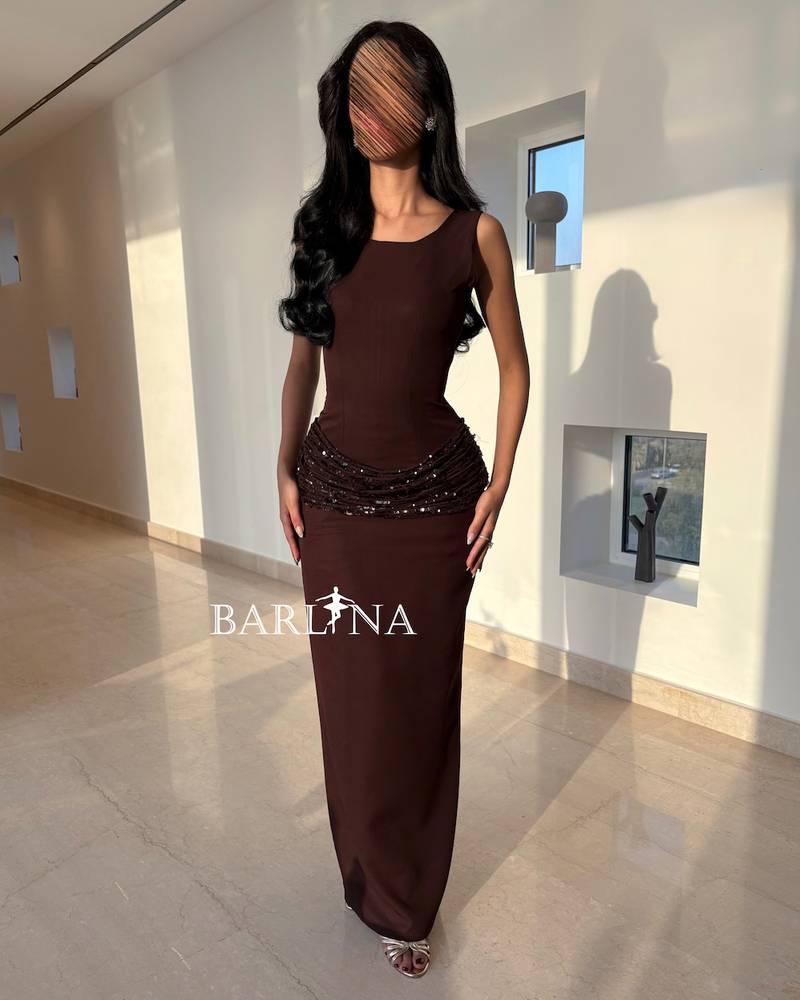Long brown dress with shiny embroidery around the waist
