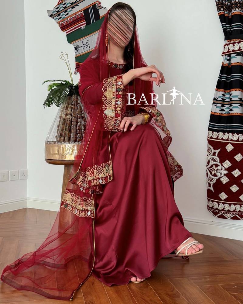 Maroon jalabiya decorated with colorful embroidery