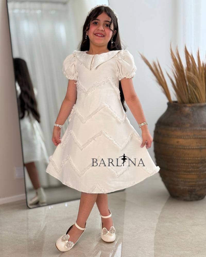 Off-white girls' dress with embroidered fabric
