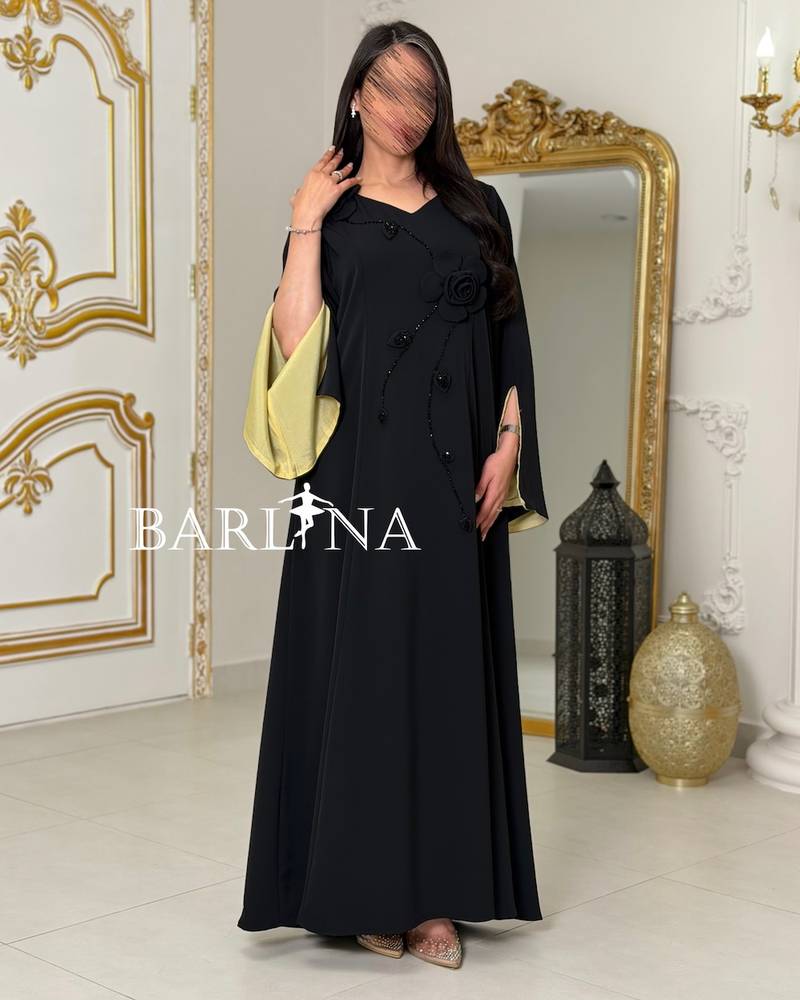 Black jalabiya with green sleeves decorated with roses