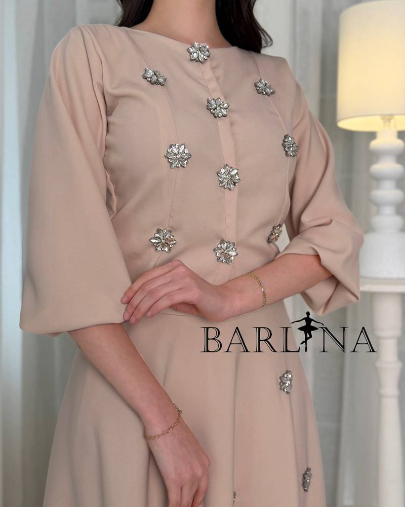 A beige set adorned with scattered shimmering embroidery