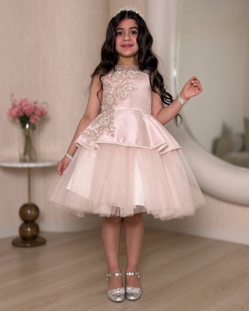 Pink girl's dress decorated with sparkly embroidery