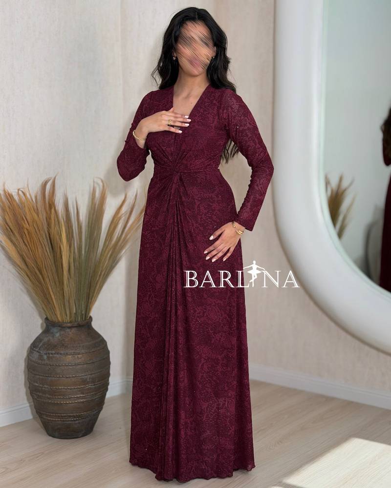 A soft burgundy dress with a cut that accentuates the waist.
