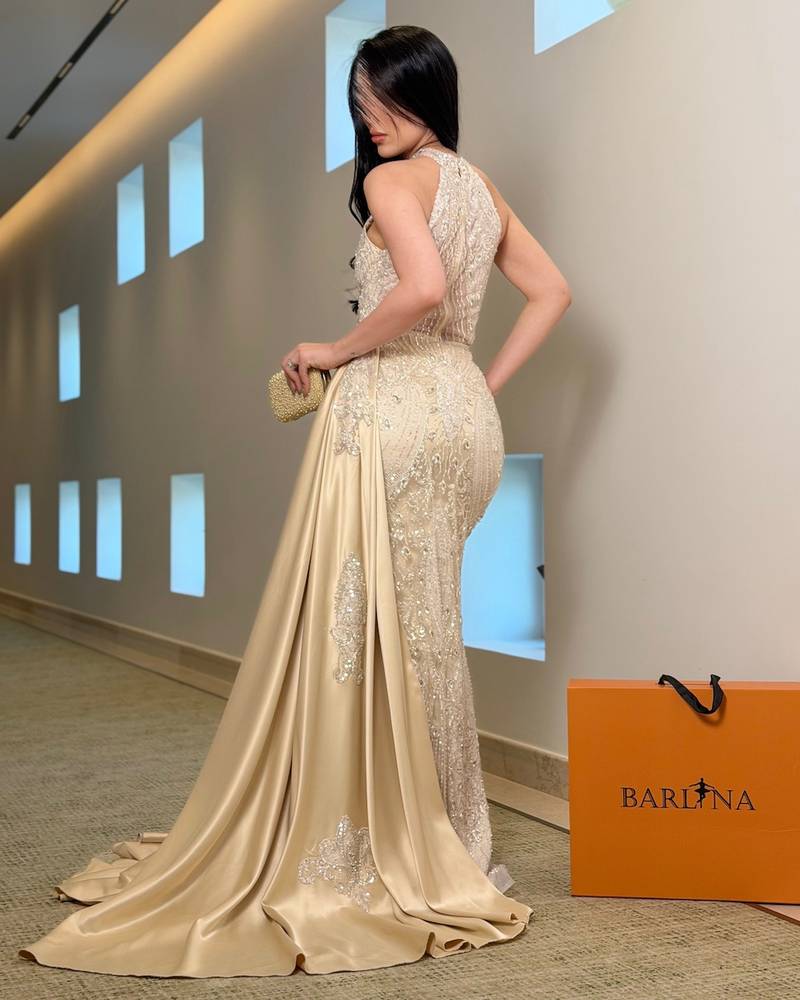 Luxurious beige evening dress with a slit at the chest