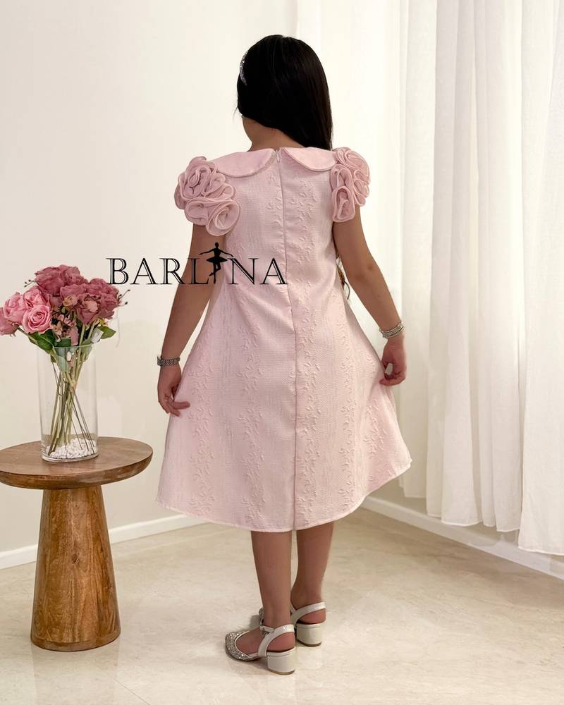 A girl's dress with a wide cut and prominent roses