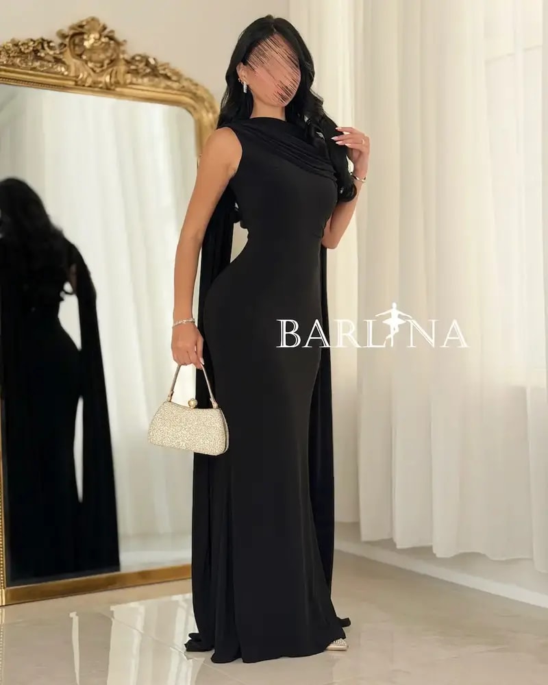 A soft black dress with a luxurious side sash.