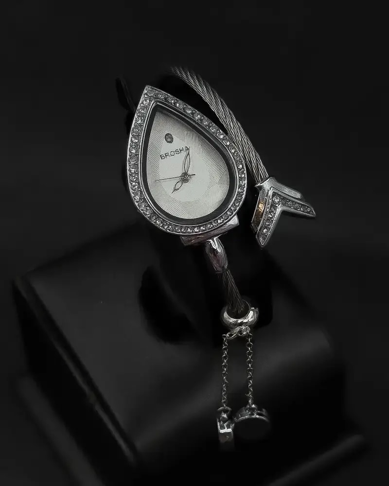 Teardrop-shaped wristwatch adorned with sparkling crystals