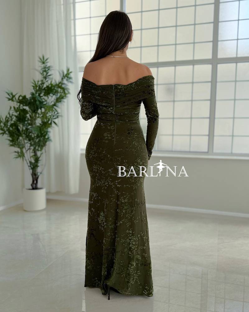 A green dress with a subtle pattern and a hint of shine.