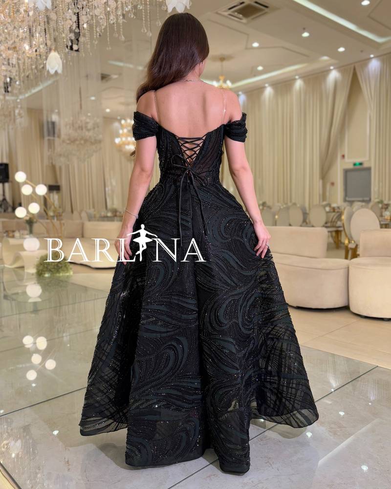 Black off-the-shoulder dress with wavy fabric