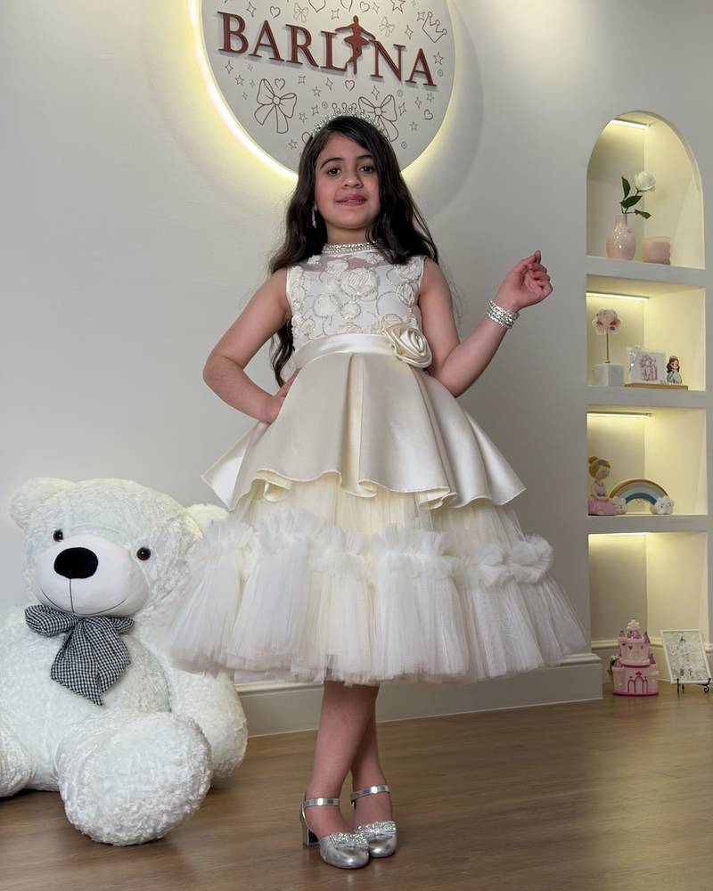 Girls' dress with elegant tiers and a side rose
