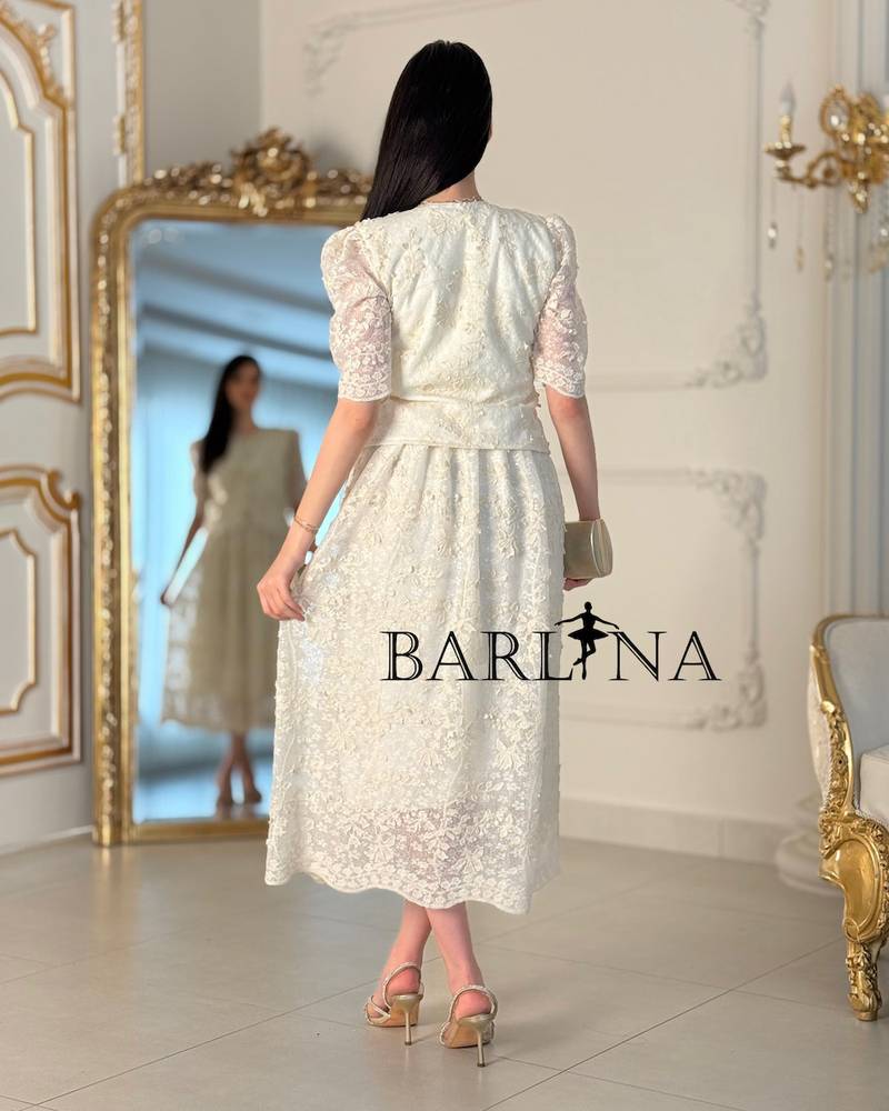 A two-piece off-white dress with an elegant lace design