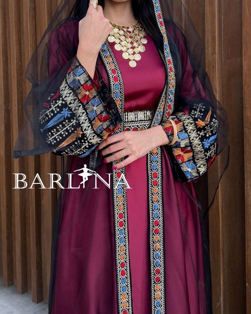 Red jalabiya with colorful traditional embroidery