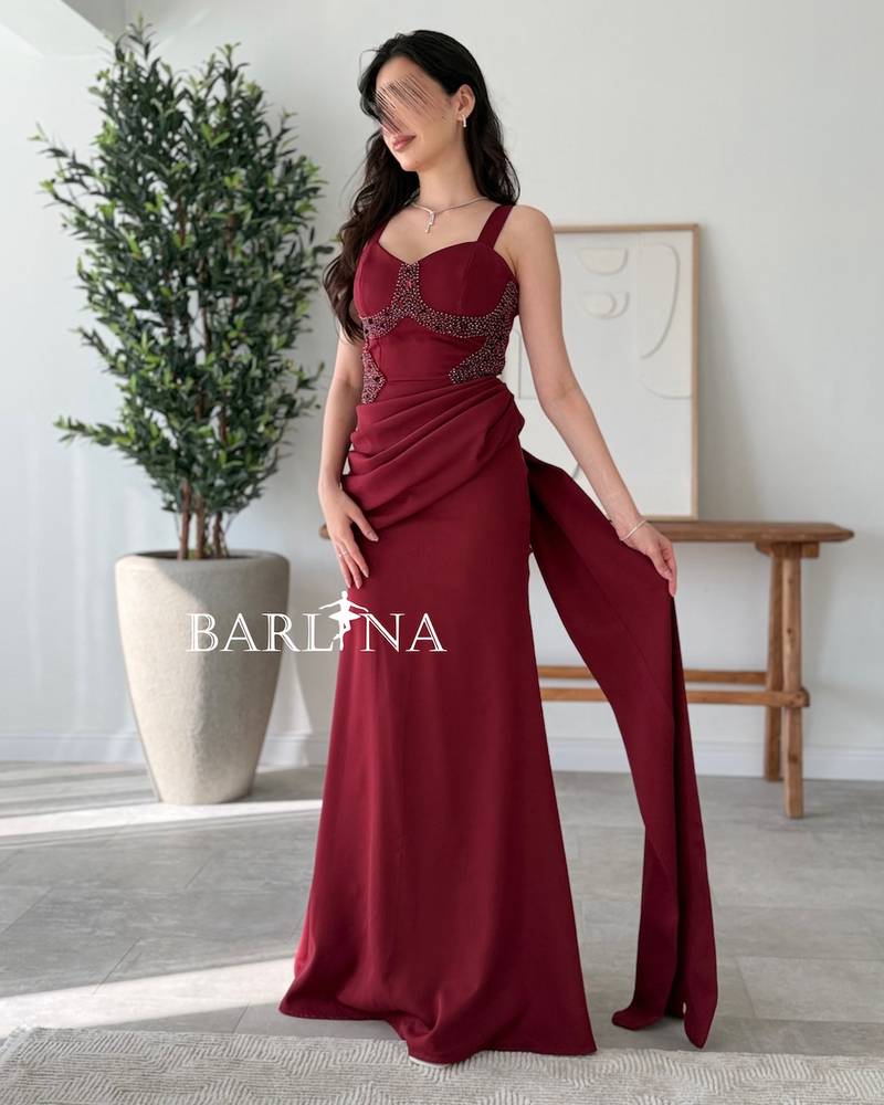 Long burgundy dress decorated with sparkling beads