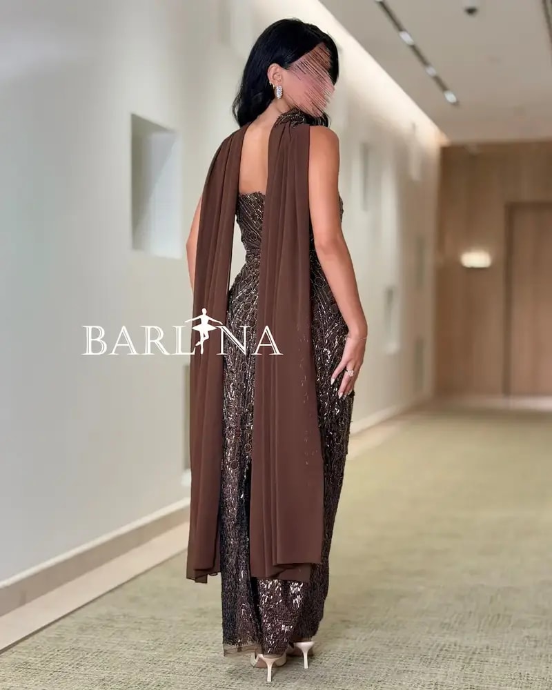 A shimmering brown dress with luxurious details and a shawl