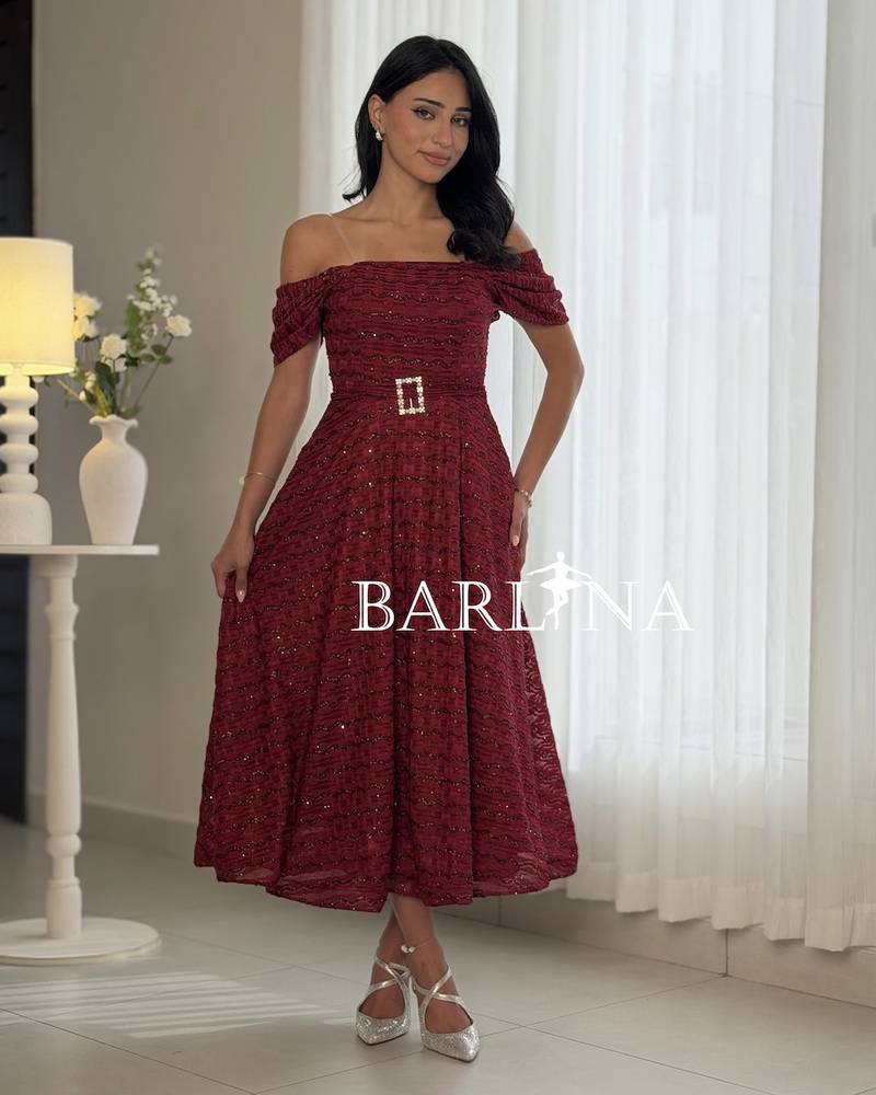 A burgundy dress with a patterned glossy fabric
