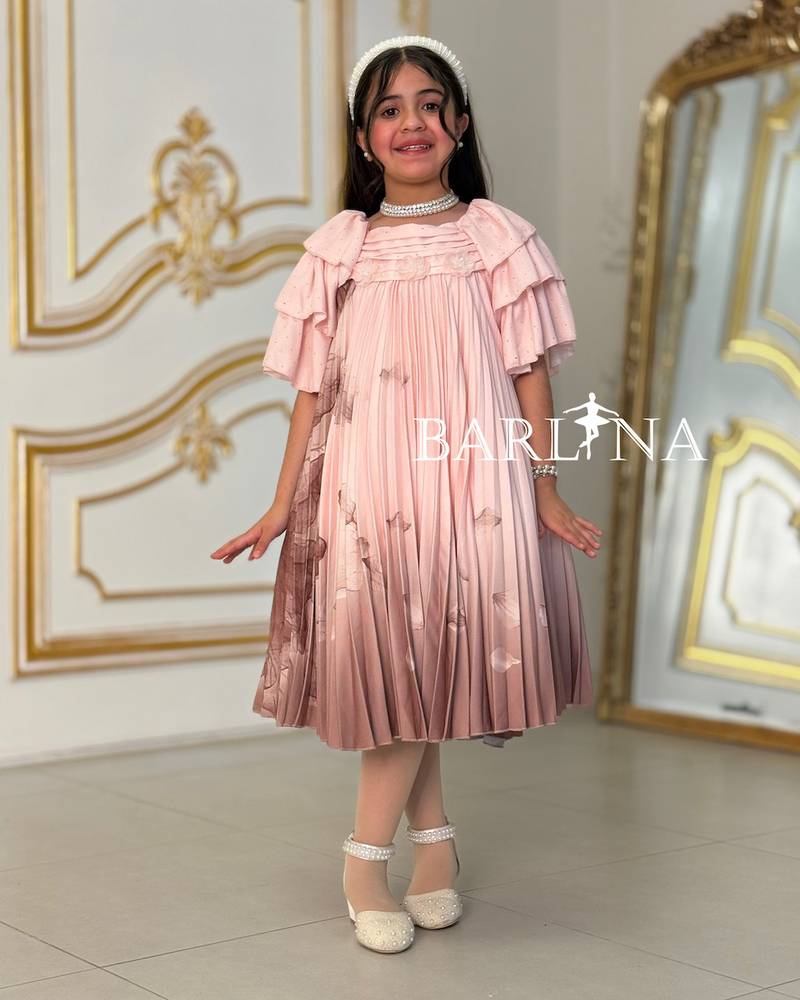 A soft girl's dress decorated with delicate prints