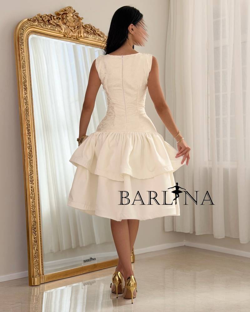 A soft dress with a low waist and layers of ruffles