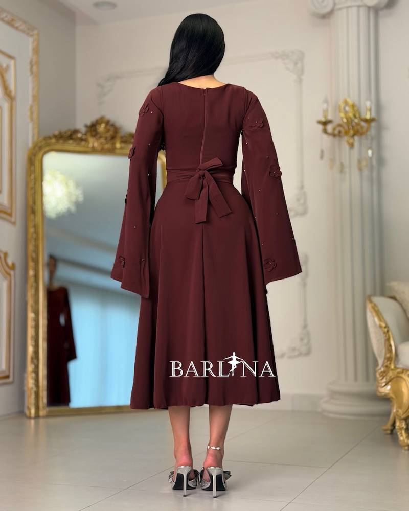 Burgundy dress with sleeves adorned with prominent roses
