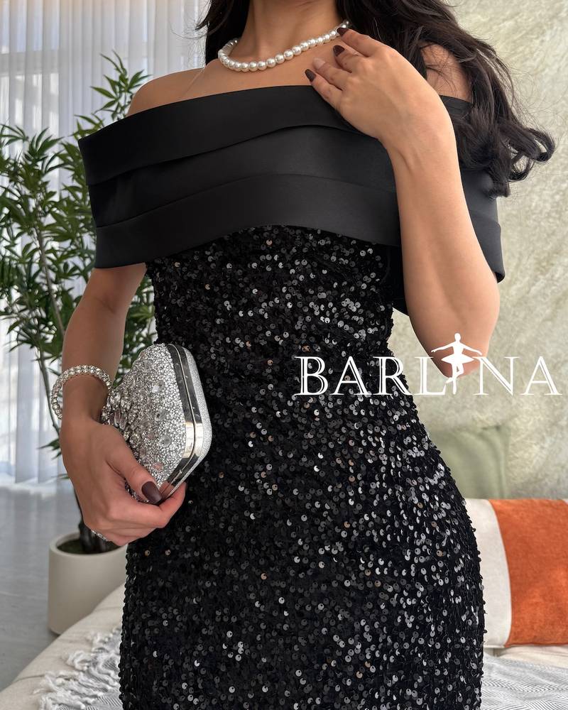 Black shiny dress with a long and distinctive design