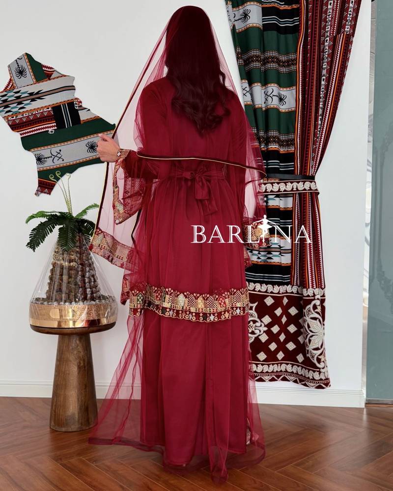 Maroon jalabiya decorated with colorful embroidery