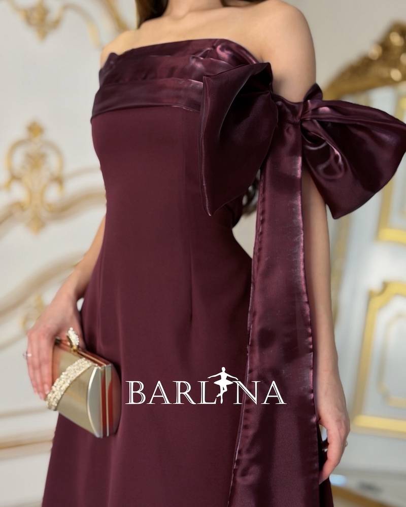 A burgundy off-the-shoulder dress with an elegant design